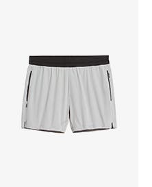 White athletic shorts with black waistband and zippers.