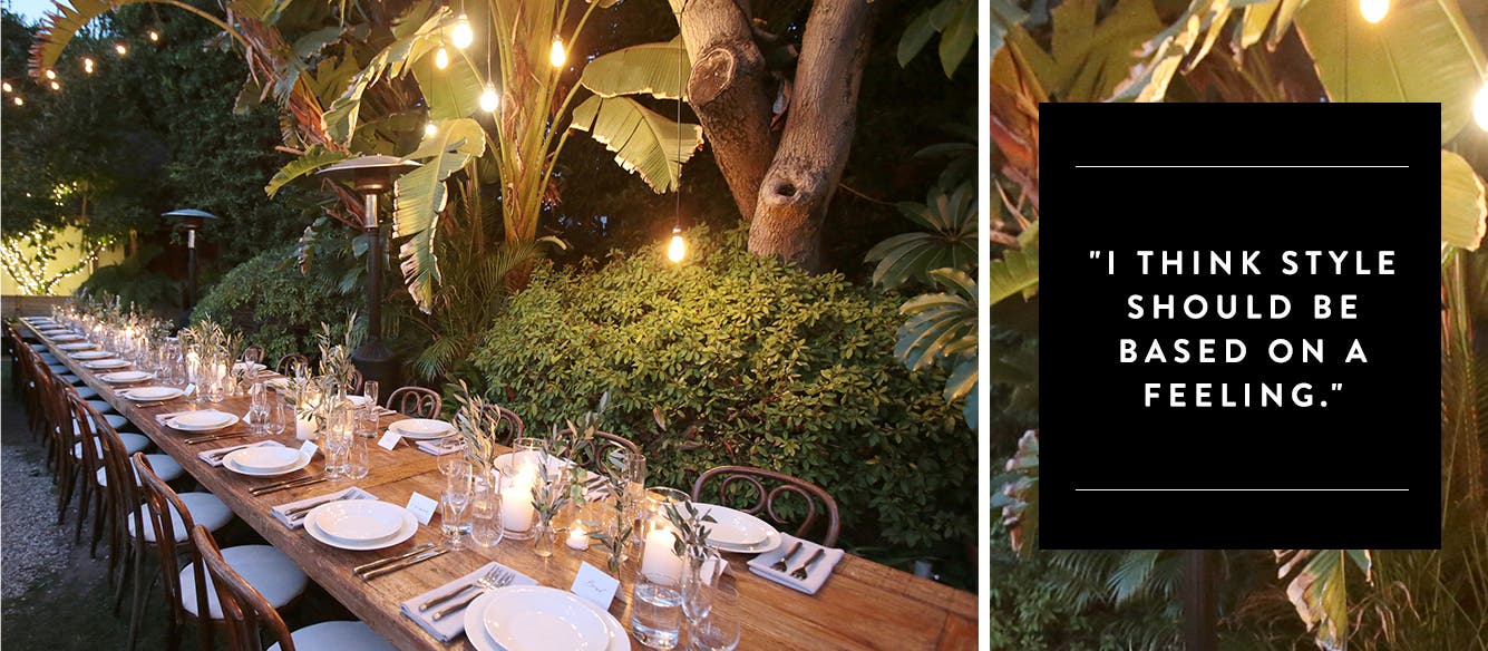 A table setting under string lights and palm trees.