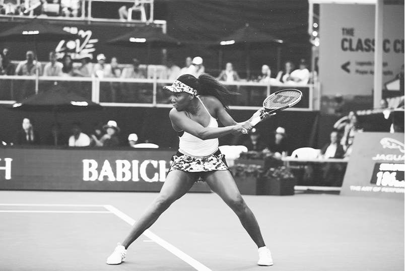 Action shot of tennis champion Venus Williams playing in a match.