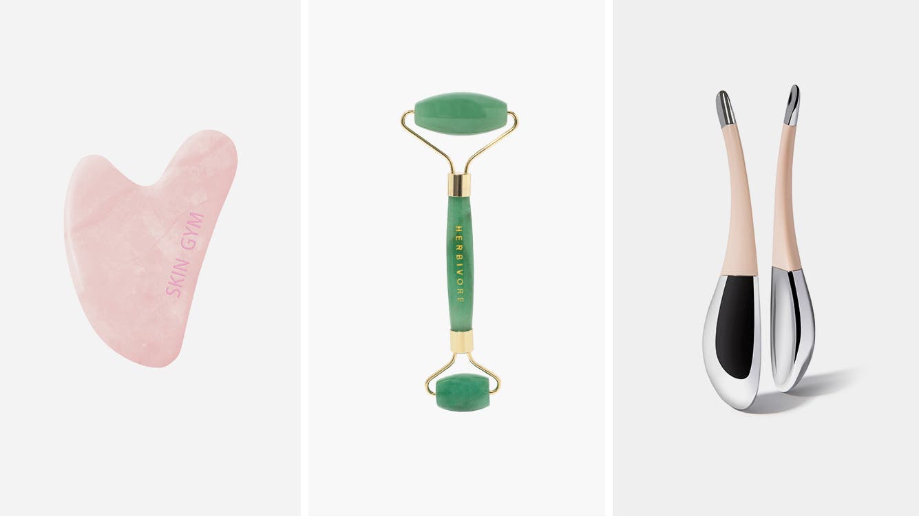 A gua sha tool, jade roller and pair of facial globes.