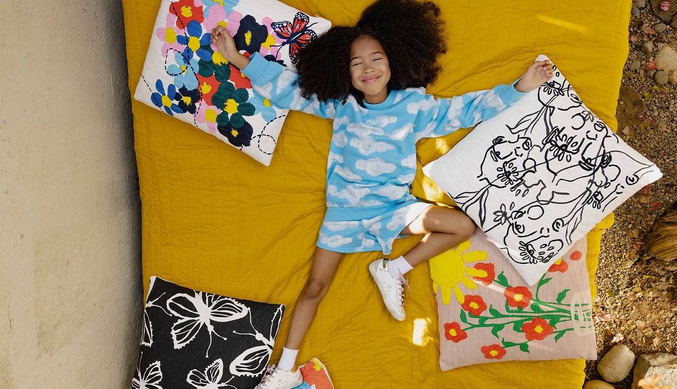 Cristina's kids wear Nordstrom by Cristina Martinez, surrounded by pillows from the new collection.