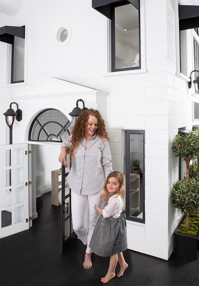 Grayson founder Audrey McLoghlin and her daughter in front of the brand's life-size dollhouse.