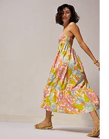A woman wearing a floral-print midi dress.