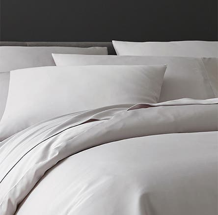 White pillows and a light grey duvet cover.