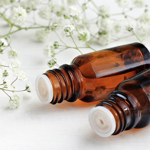 Two amber-colored bottles of essential oil.