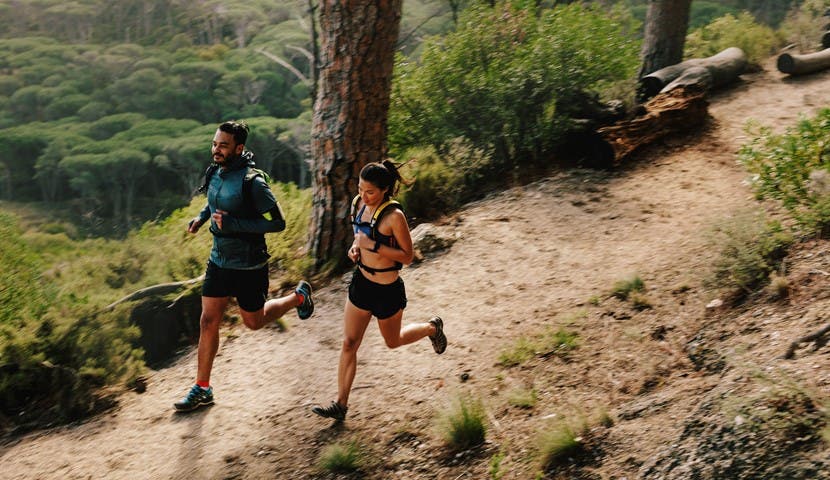 man and woman trail running