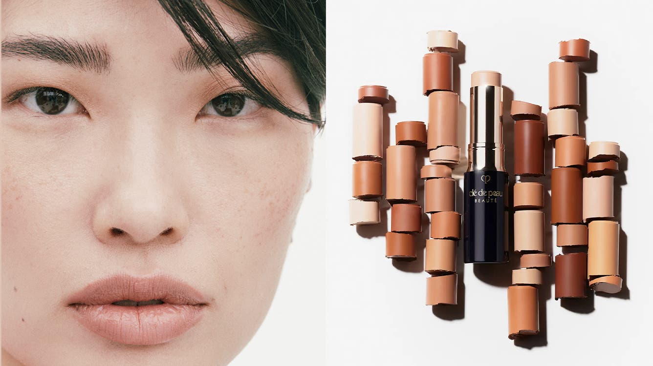 Close-up of a woman model with minimal makeup; a tube of Clé de Peau Beauté Concealer surrounded by cut-up pieces of the same concealer stick in different shades.