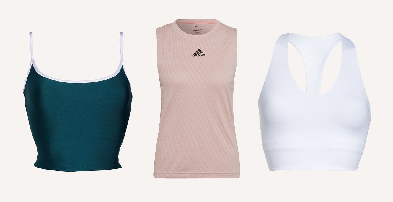 A dark teal cropped tennis camisole; a pink adidas sleeveless top; a white racerback sports bra.