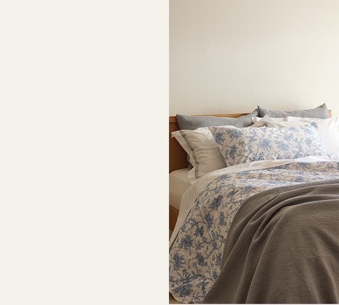 Crisp bedding in solid neutrals and botanical prints.