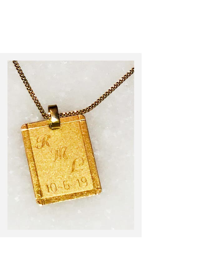 A necklace given to founder Shirley Cook by her fiancé, with the initials of their son.