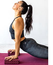 Woman doing yoga in coordinating active crop tank and leggings.