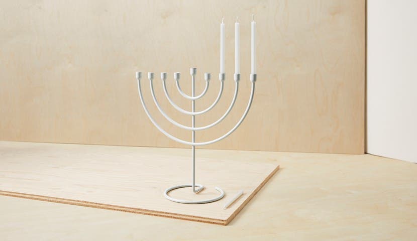 silver menorah with candles and minimal background