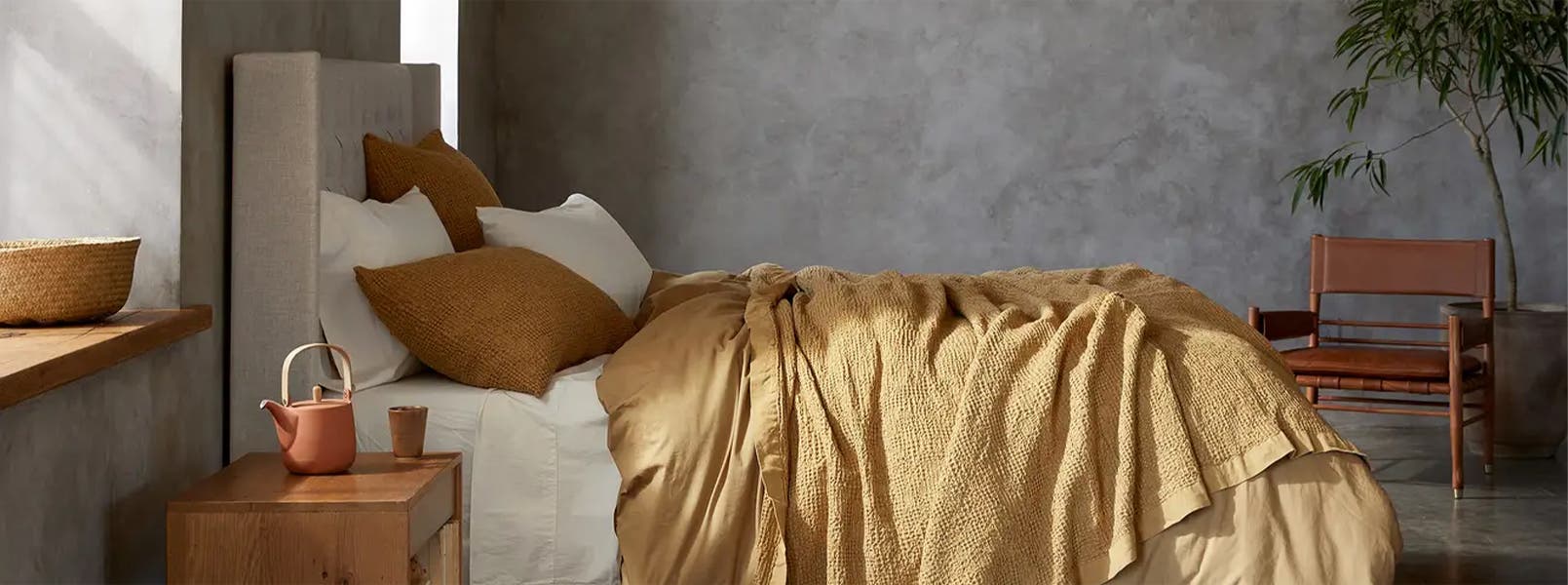 Knit blankets; a patterned cushion; a textured throw.