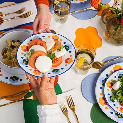 Colorful floral-patterned dishes and table linens.