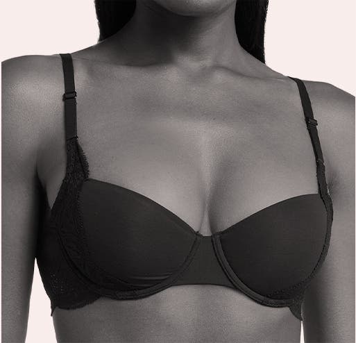 A woman models a demi bra.