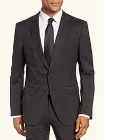 Black peak-lapel suit with black necktie.