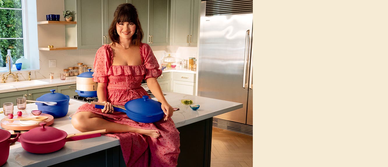 Selena Gomez in a kitchen with the Always Pan and Perfect Pot in blue and rose.