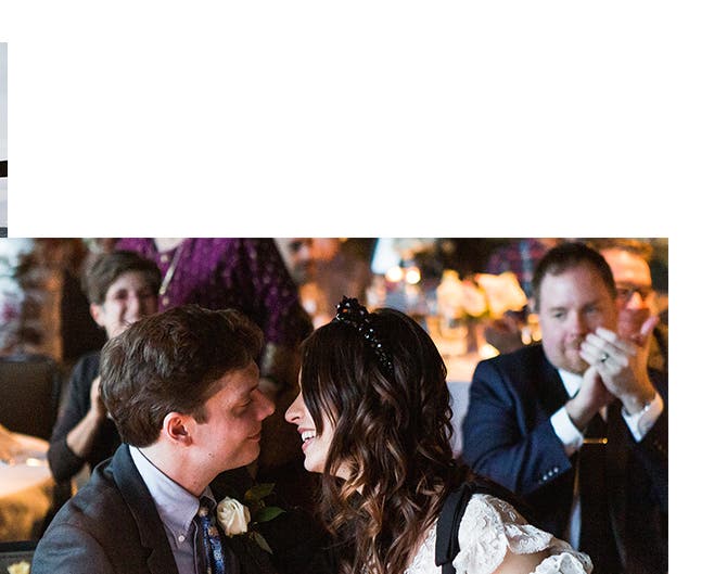 The bride and groom share a special moment at their table during the reception.