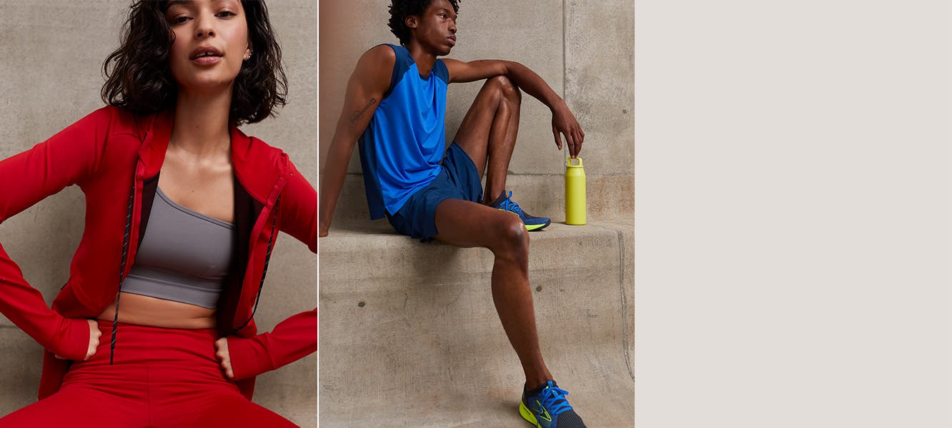 Woman wearing a red active hoodie and leggings and grey sports bra. Man in blue active clothing and shoes.