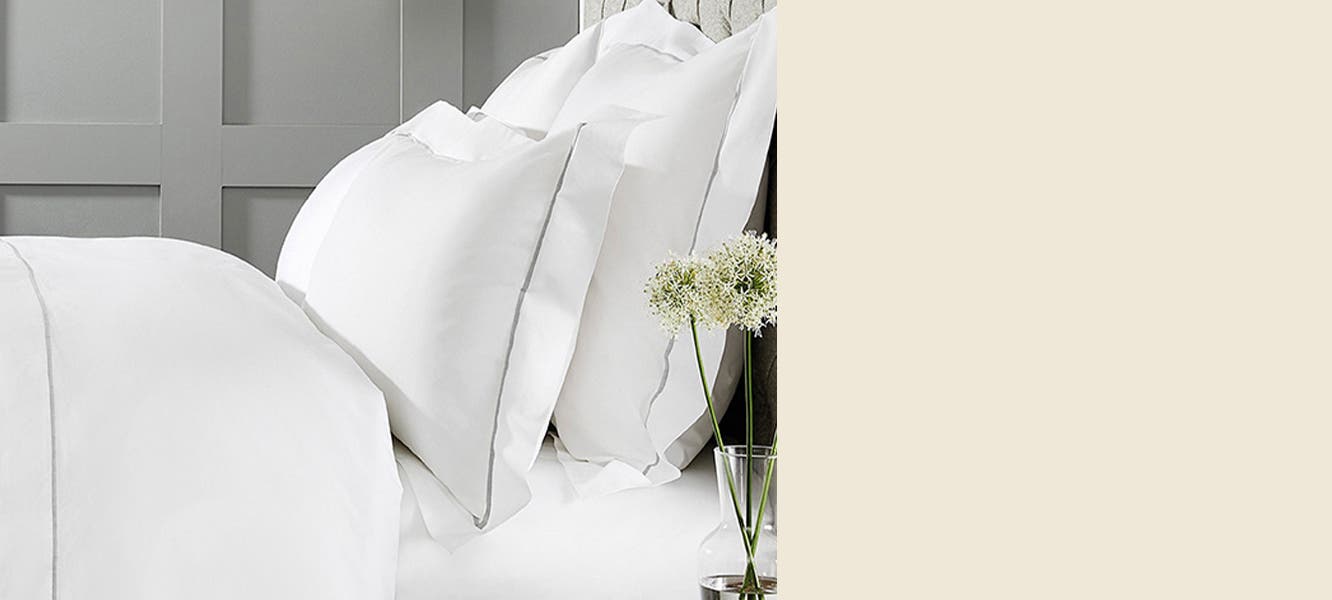 White cotton sheets, pillowcases and shams.