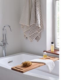 Towels hanging by a bathtub.