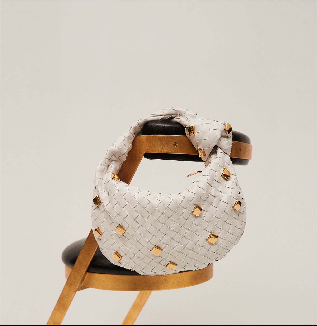 Cream studded Bottega Veneta bag.