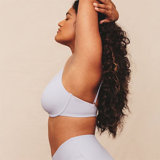 Model wearing a white bra and underwear.
