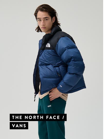 Man wearing a blue jacket from The North Face and green sweatpants from Vans.