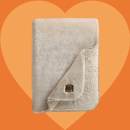 Cozy gifts for Valentine's Day: a plush beige UGG blanket.