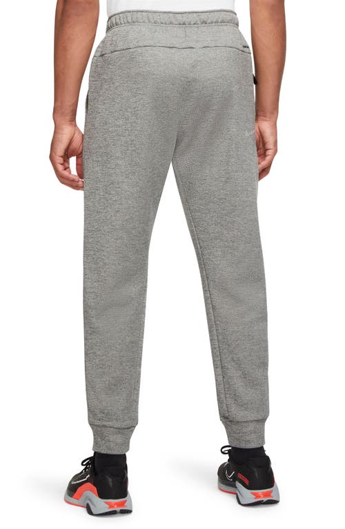 Shop Nike Therma-fit Tapered Training Pants In Dk Grey/particle Grey/black