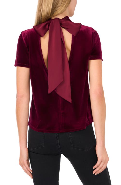 Shop Cece Mock Neck Cutout Stretch Velvet Top In Majestic Wine