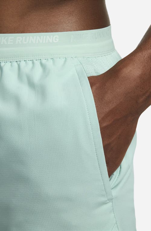 Shop Nike Dri-fit Stride 5-inch Running Shorts In Mineral/jade Ice
