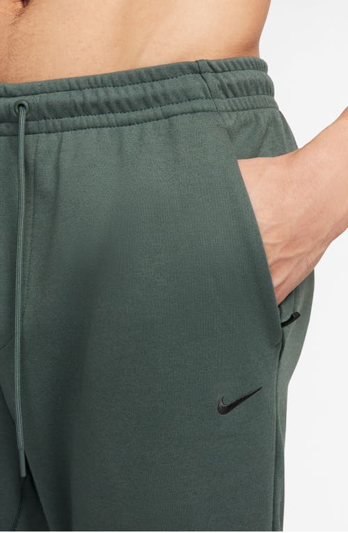 Shop Nike Primary Dri-fit Joggers In Vintage Green/vintage Green