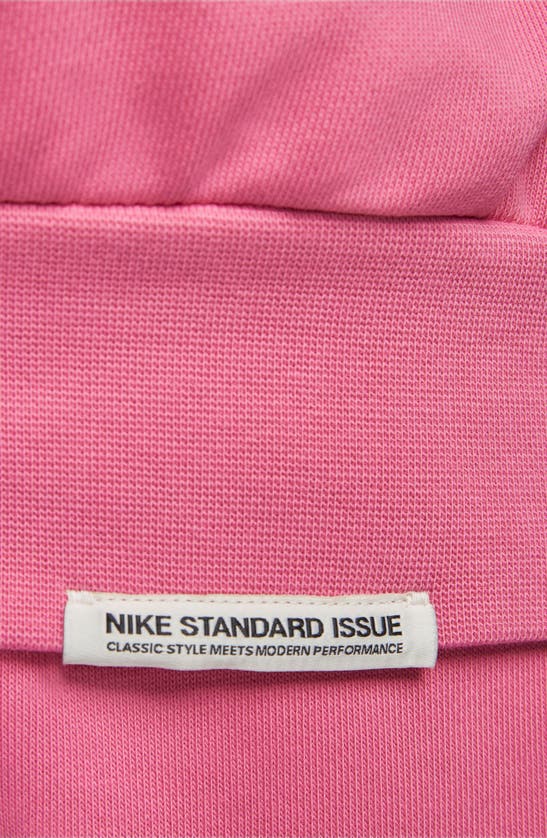 Shop Nike Dri-fit Standard Issue Hoodie Sweatshirt In Pinksicle/ Pale Ivory