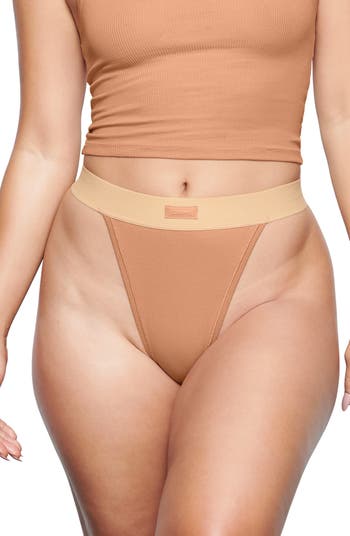 SKIMS - The Cotton Rib Thong ($20) in Mineral — available now at SKIMS.COM.  Shop the Cotton Collection and receive free shipping on domestic orders  over $75.