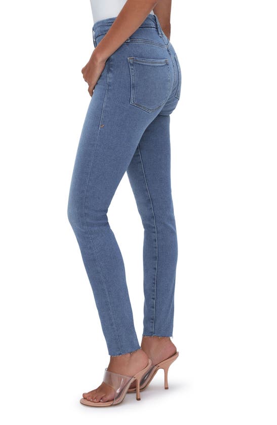 Shop Good American Good Legs Raw Hem Mid Rise Skinny Jeans In Blue655