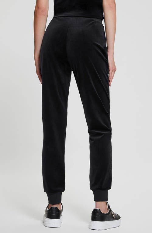 Guess Couture Crystal Logo Embellished Velour Joggers In Jet Black