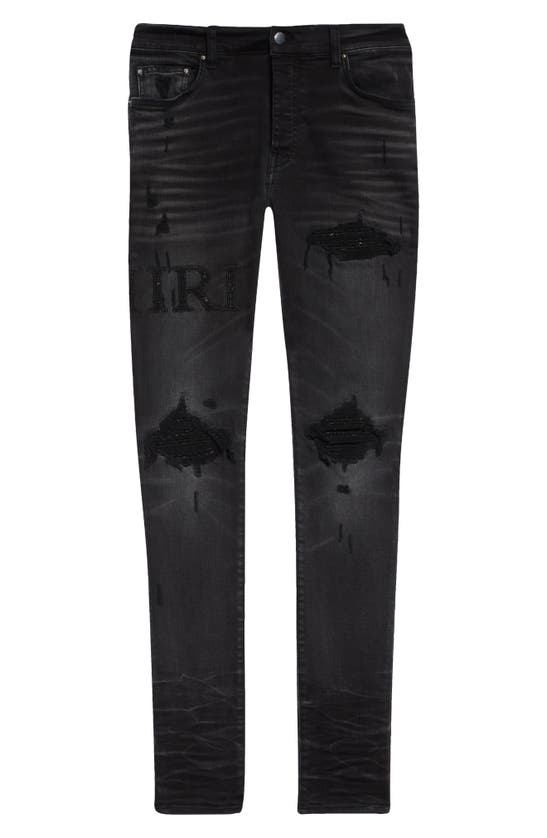 Amiri Bouclé Logo Ripped Mx1 Skinny Jeans In Faded Black
