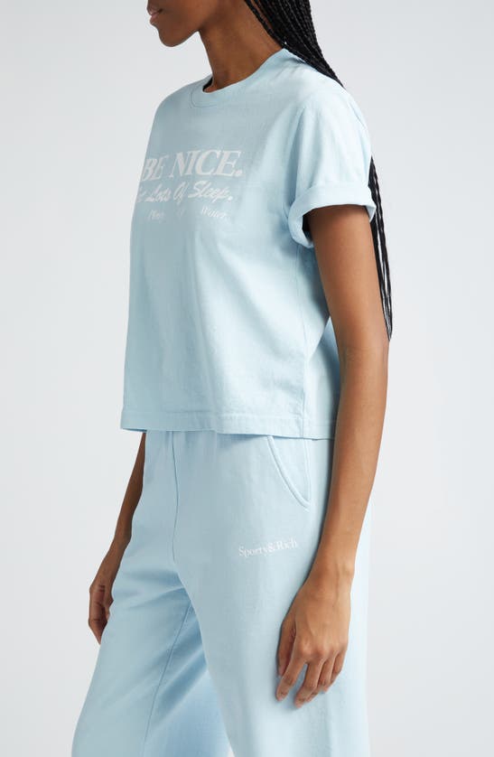 Shop Sporty And Rich Be Nice Cotton Crop Graphic T-shirt In Baby Blue
