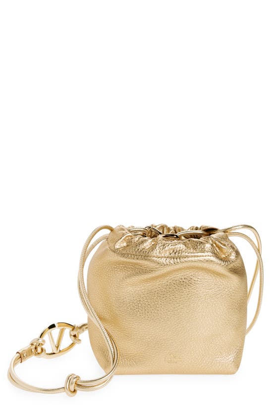 Valentino Garavani Mini Vlogo Metallic Leather Drawstring Bag In Gold