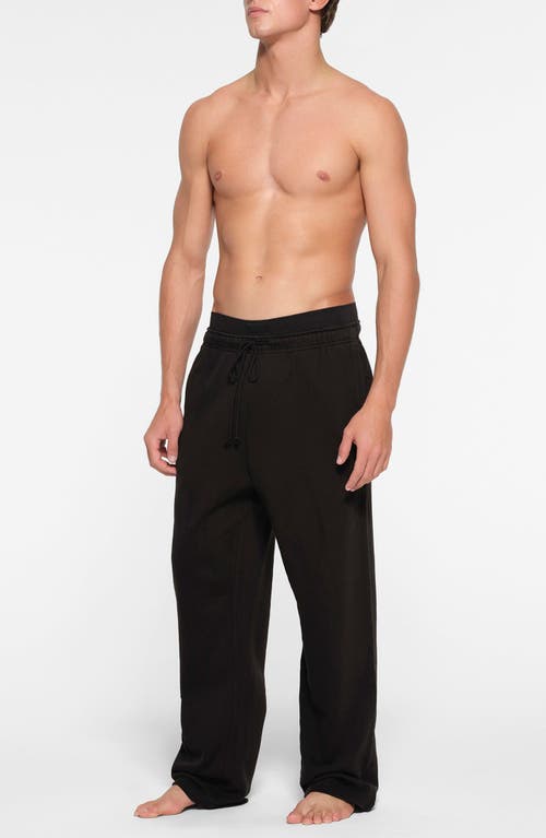 Shop Skims Straight Leg Cotton Lounge Pants In Washed Obsidian