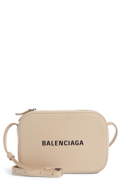 Click to view more detailed imagery on our partner's website Balenciaga Extra Small Everyday Calfskin Camera Bag - Beige In Light Beige/ Black