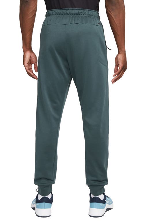 Shop Nike Therma-fit Tapered Training Pants In Deep Jungle/black