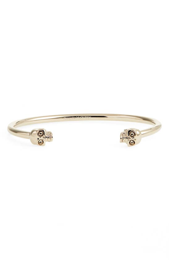 Alexander Mcqueen Twin Skull Cuff Bracelet In Gold