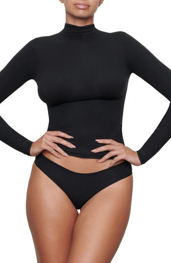 SKIMS - Kylie Jenner wears the Essential Mock Neck Long Sleeve Bodysuit in  Onyx - avaliable now in 7 colors and sizes XXS - 5X. Shop Essential  Bodysuits