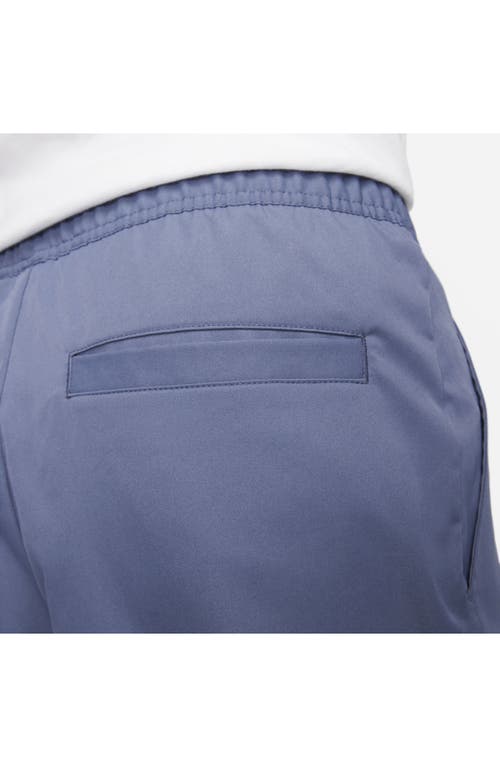 Shop Nike Woven Tapered Leg Pants In Diffused Blue/white