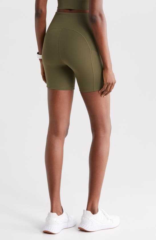 Shop Zella Studio Luxe Pocket Bike Shorts In Olive Night