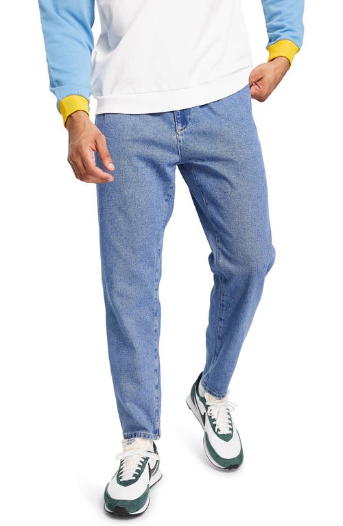 ASOS DESIGN Double Pleat Tapered Jeans in Medium Blue