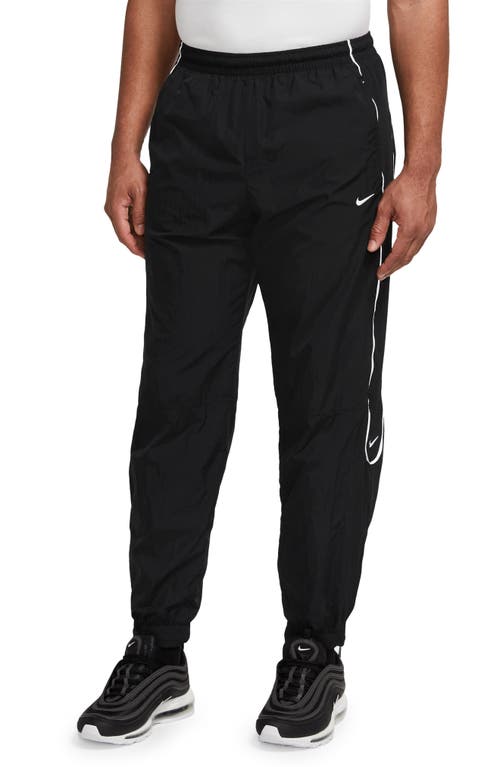 Solo Swoosh Water Repellent Track Pants in Black/White
