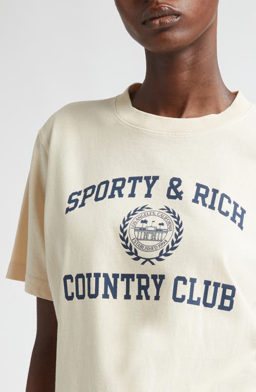 Shop Sporty And Rich Sporty & Rich Varsity Crest Cotton Graphic T-shirt In Cream